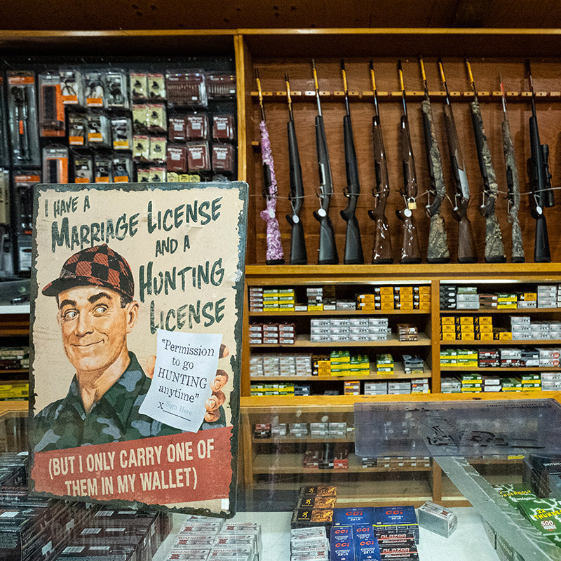 Hunting license sign and rifle display